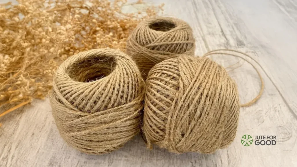 Natural jute twine balls on wooden surface