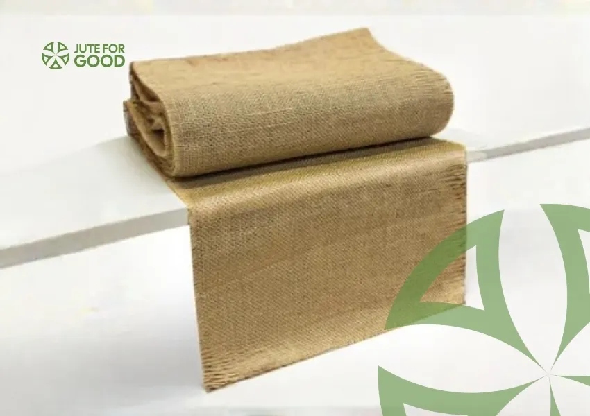 Rolled jute fabric placed on a white table.