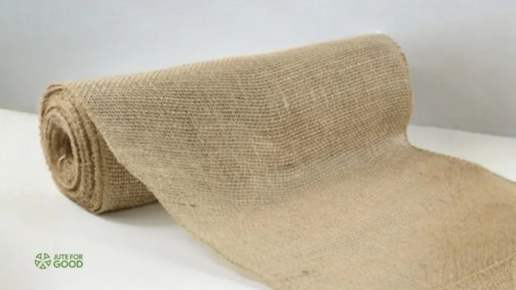 Rolled jute fabric placed on a white table.